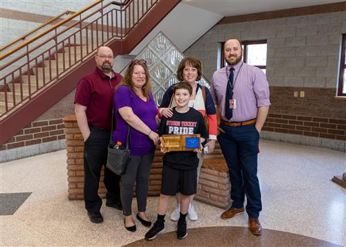 Photo of Jimmy Weiss, family members, Principal Gloystein, and Assistant Principals Basile and Koval.