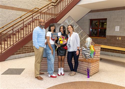 A'zari Hemphill, Wilson's November Stairclimber, poses with her plaque, family members and Assistant Principal Wright.