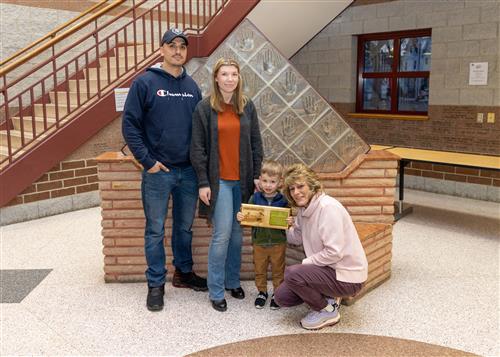 Lincoln's March Stairclimber, Connor Schenberg, posing with his plaque and family members.