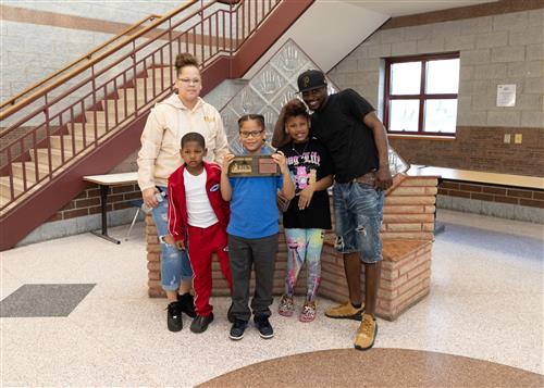 Gary Thompson, Pfeiffer-Burleigh Elementary's April Stairclimber, poses with his plaque and family members.