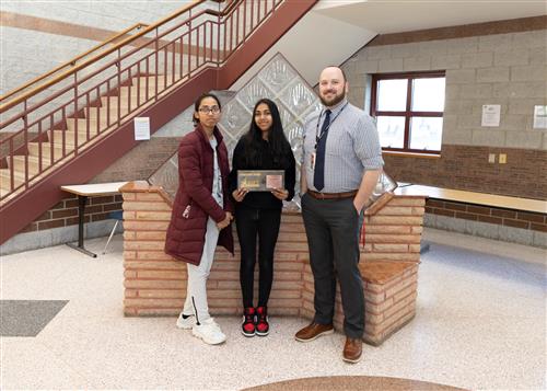 Allena Butt, East Middle School's April Stairclimber, poses with her award, a family member and Principal Koval.