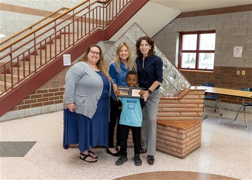 Ja'King Griffin, Patrick J. DiPaolo Student Success Center Stairclimber for May 2023, poses with his plaque, family.
