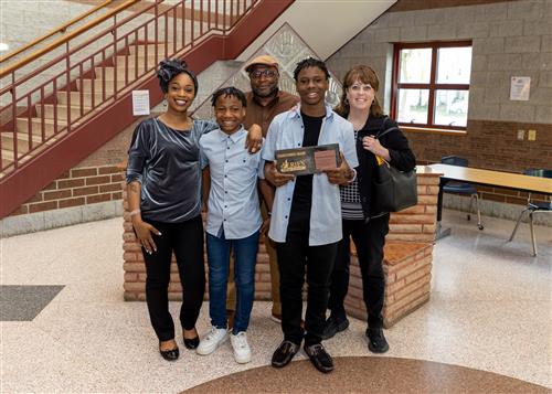 Iyzaren Woodard, Strong Vincent Middle School's May 2023 Stairclimber, poses with family and Principal Gloystein.