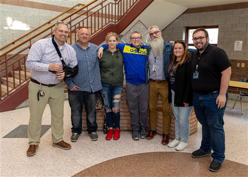 Tyler Dembski, Jefferson Elementary's May 2023 Stairclimber, poses with his plaque, family members and school administrators.