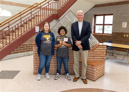 Jamari Miller, Diehl Elementary's May 2023 Stairclimber, poses with a family member and Principal Tim Sabol.