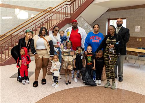 Sa'Riah Clark, Eagle's Nest May 2023 Stairclimber, poses with her plaque, family members and Ken Nickson.