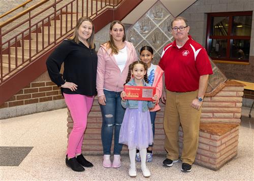 Aubrey Ferrara, McKinley's February Stairclimber, poses with her plaque, family members and Principal Dana Suppa.