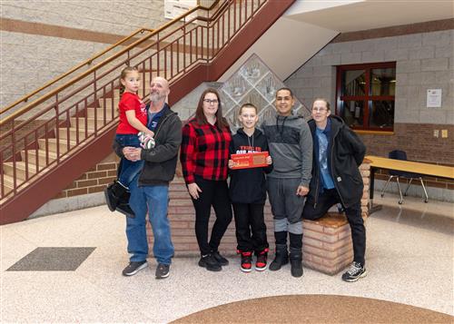 Brandon Lozada, Strong Vincent's February Stairclimber, poses with his plaque and family members.