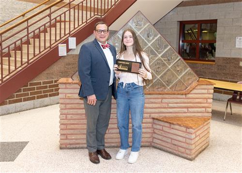 Enisa Siljkovic, Collegiate's December Stairclimber, poses with her plaque and Dean Jim Vieira.