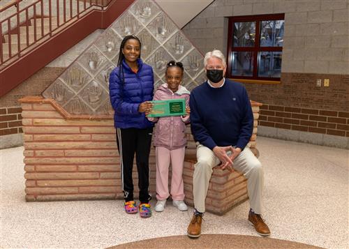 Photo of Diehl's March Stairclimber, Cela Fatuma, with family and Principal Sabol.