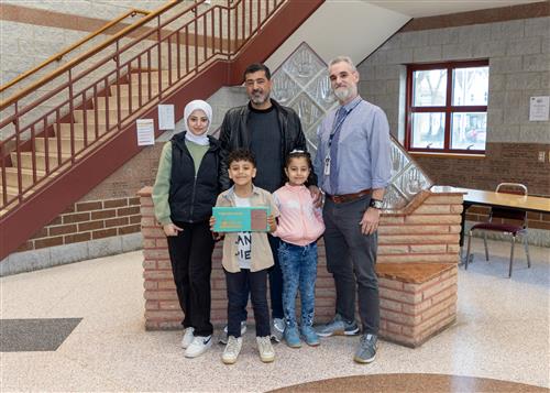 Omar Al Baradan, Jefferson's March Stairclimber, poses with his plaque, family members, and AP Bayhurst.