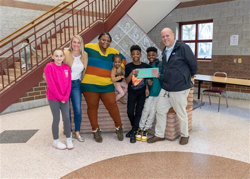 Ayden Anderson, Harding's March Stairclimber, poses with his plaque, family members, and AP Jeff Yonkers.