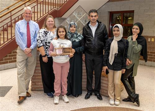 Aya Hasryeh, Diehl's November 2022 Stairclimber, posing with family members and Principal Tim Sabol.