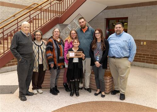 Savana Gailey, JoAnna Connell's November 2022 Stairclimber, posing with family members and Principal Rob Causgrove.