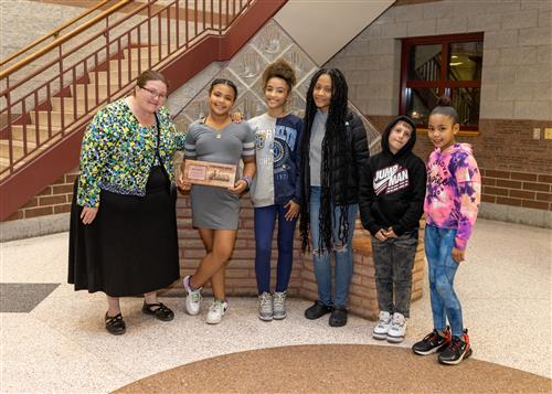 Jaila Jordan, Lincoln's November 2022 Stairclimber, with family and Principal CJ Huffman