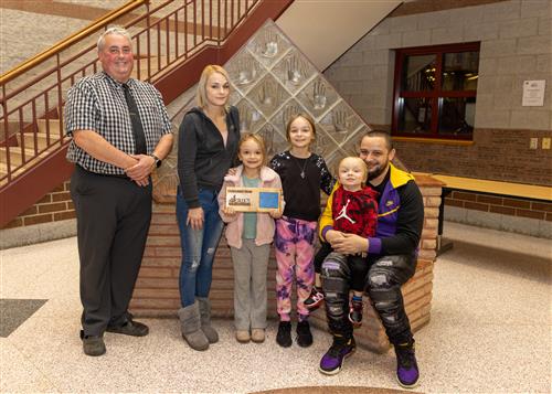 Kylie Stone, Grover Cleveland's December Stairclimber, posing with her plaque, family members and AP Dennis Carner.