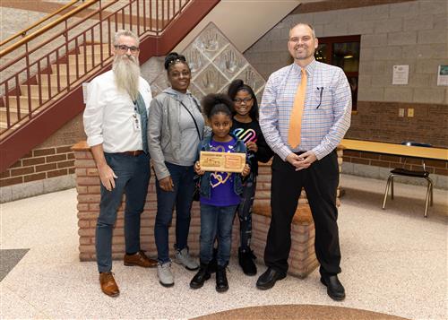 Selah Carlisle, Jefferson's January 2023 Stairclimber, standing with family and school staff.