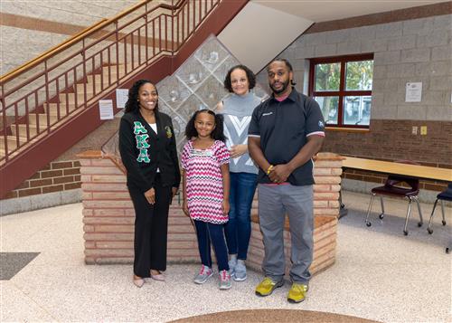 London Marion, Grover Cleveland's October Stairclimber, poses with family members and Principal McFarland.