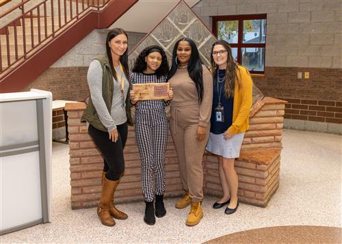 Paris Robinson, JoAnna Connell's October 2022 Stairclimber, posing with family and school staff.