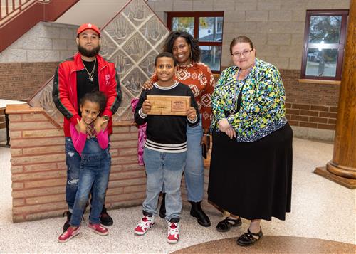 Lincoln Elementary School's October 2022 Stairclimber, Ezekiel Clayton, with family and Principal C.J. Huffman.