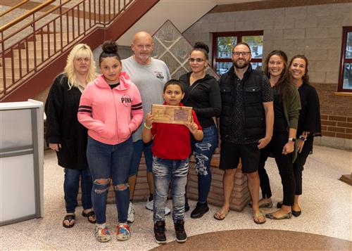 Edison Elementary School's October 2022 Stairclimber, Emmanuel "Manny" Dalton, with family and school administrators.