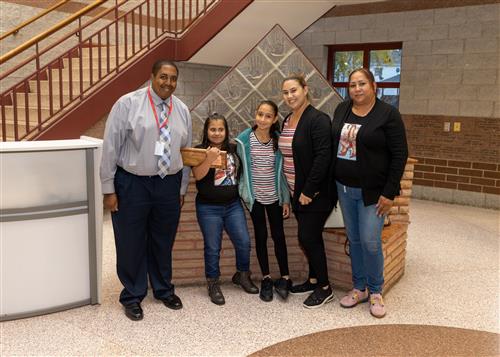 Joaneliz Velazquez, East Middle School's October 2022 Stairclimber, with family and Assistant Principal Ashton Barnes.