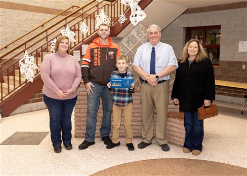 Mason Miller, Pfeiffer-Burleigh's January Stairclimber, poses with his plaque, family members and school staff.