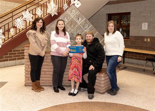 Shattqwa Knight, Perry's January Stairclimber, poses with her plaque, family members, and school staff.