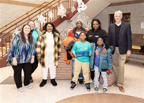 Jihmeek Seawright, Diehl's January Stairclimber, poses with his plaque, family members, and school staff.