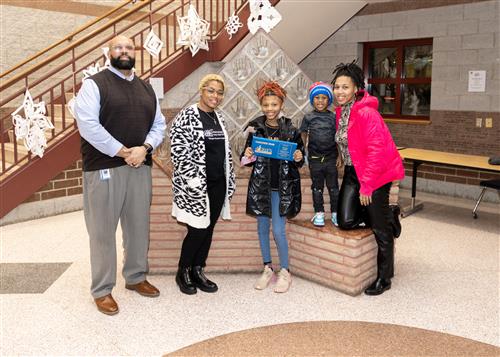 Kamryn Knight, Strong Vincent's January Stairclimber, poses with her plaque, family members, and Ken Nickson.