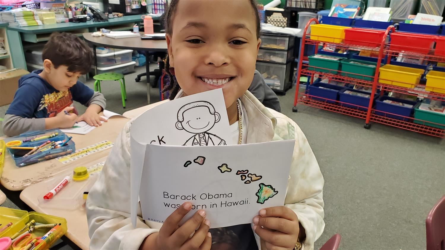 Student showing a reader about Barack Obama.