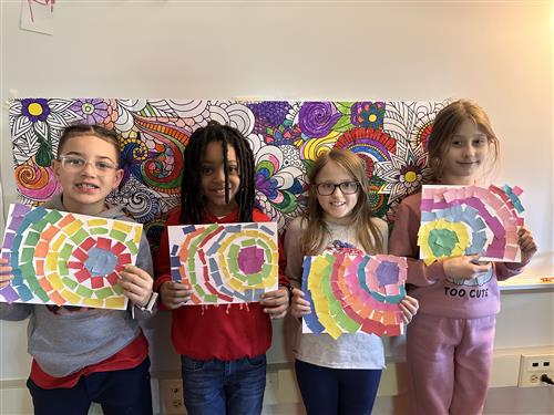 Four Harding students show off art work they made in celebration of Black History Month. Art is mosaic of swirls.
