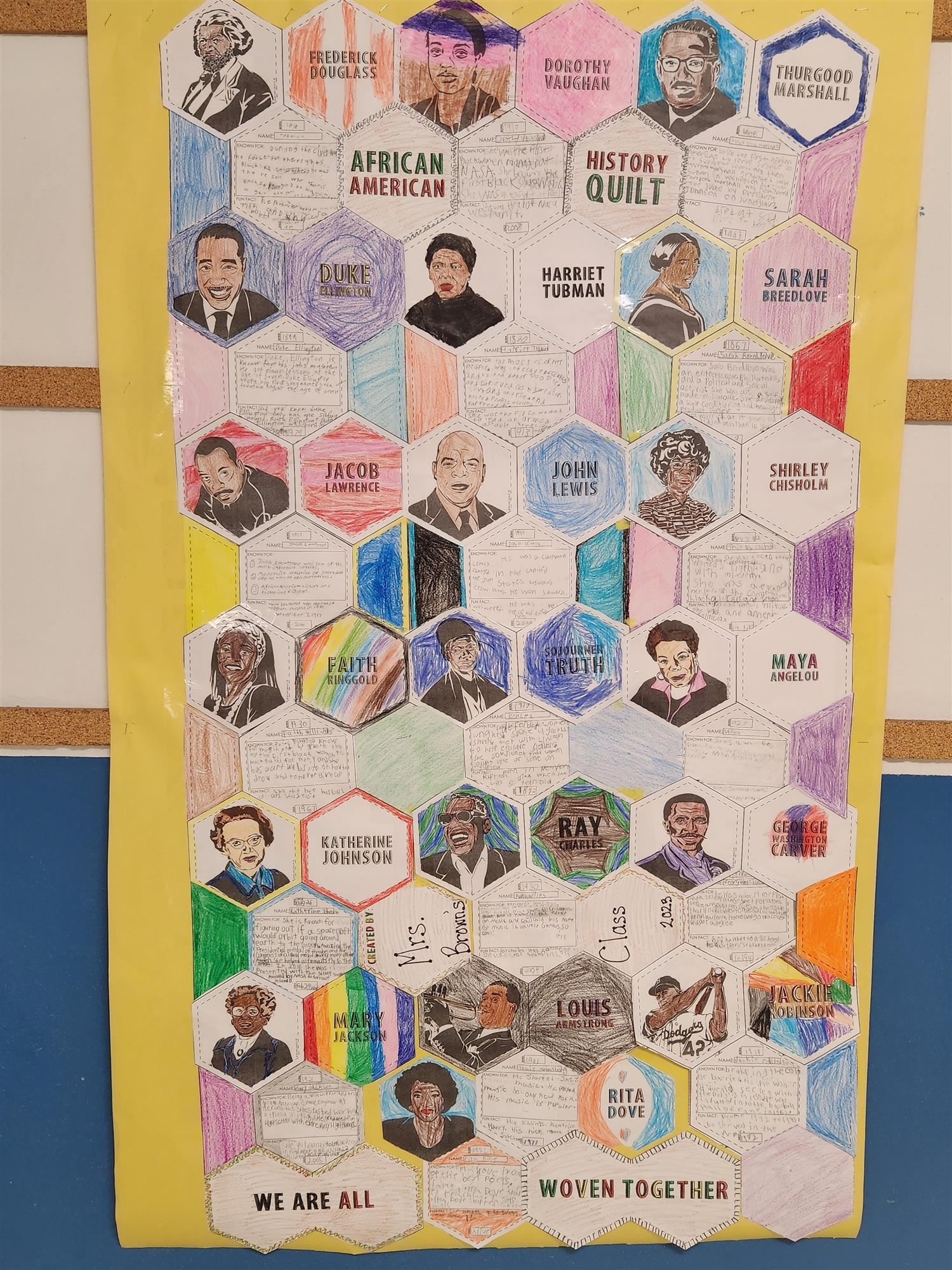 A paper "quilt" made out of interlocking hexagons featuring photos and information about famous Black Americans.