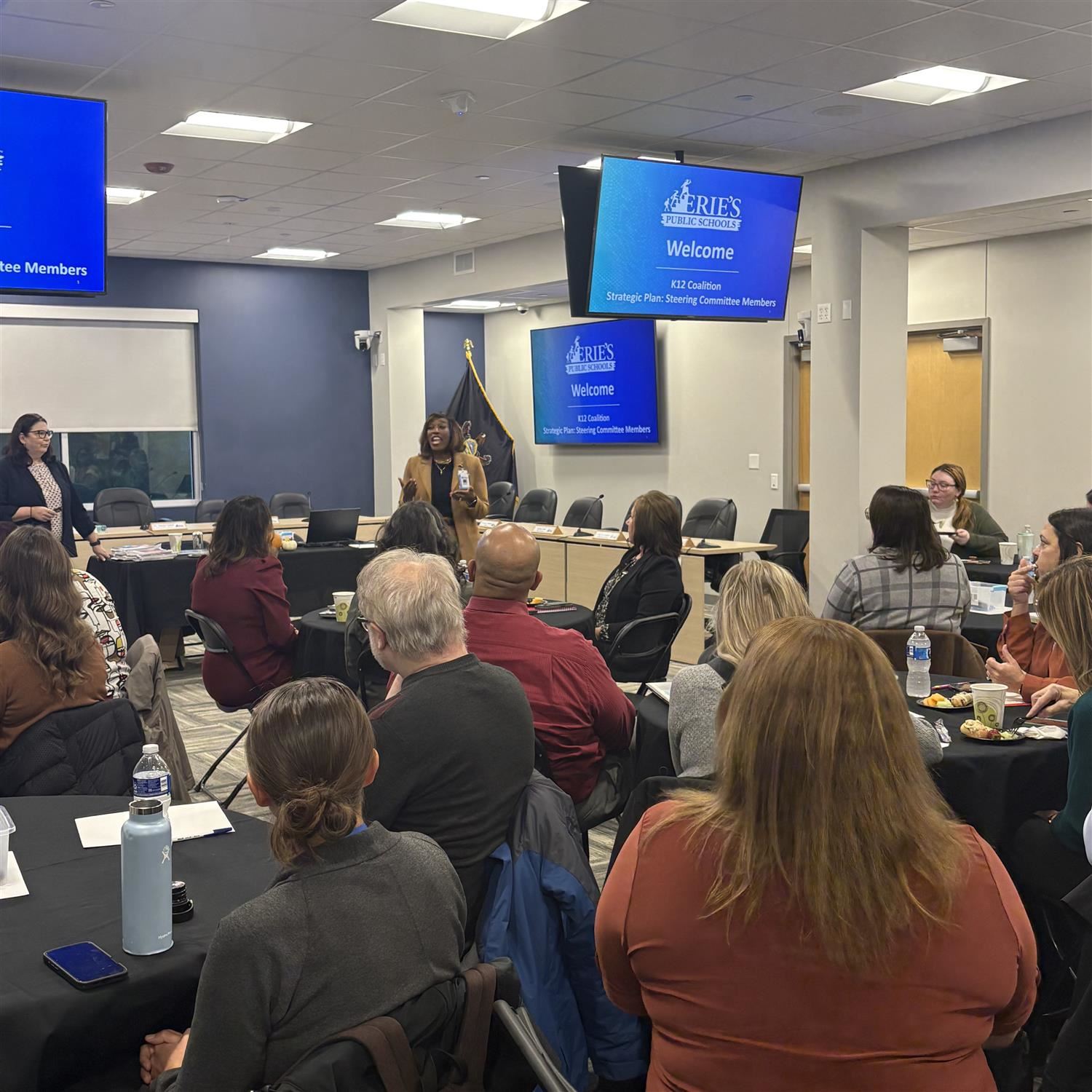CAO Gatewood talking to a room of men and women sitting at round tables.