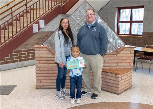 Elyjah Carson, McKinley's Stairclimber for March, poses with his plaque, a family member, and Principal Dana Suppa.