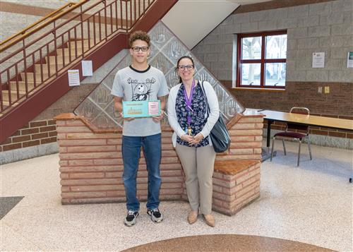 Armonii Torres, Erie High's March Stairclimber, poses with his plaque and AP Anna DePaul.