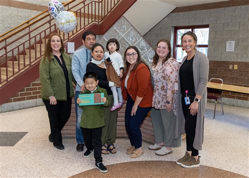 Mahin Limbu, Edison's March Stairclimber, poses with his plaque, family members, and school staff.