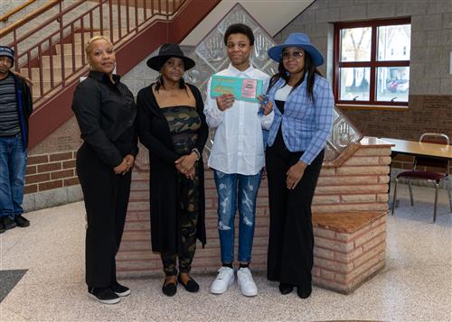 Avion Stewart, Eagle's Nest's March Stairclimber, poses with his plaque and family members.