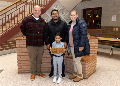 Harding's January 2023 Stairclimber, Zain Almurailheg, standing with family and school staff.