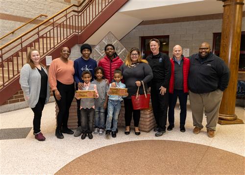 Perry's January 2023 Stairclimbers, Jordan and Jakobe Boone, standing with family members and school staff.