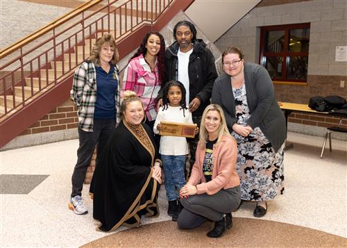 Josiah Williams, Lincoln's January 2023 Stairclimber, posing with familiy members and school staff.