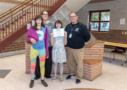 Victoria Hatton, McKinley's October Stairclimber, poses with her certificate, family members, and Principal Dana Suppa.