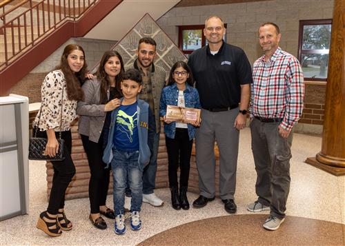 Rahaf Waleed, Jefferson Elementary School's October 2022 Stairclimber, posing with family members and school staff.