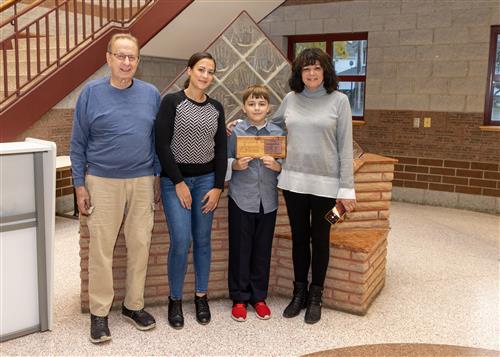 Bentley Vollmer, Grover Cleveland's October 2022 Stairclimber, posing with family members.
